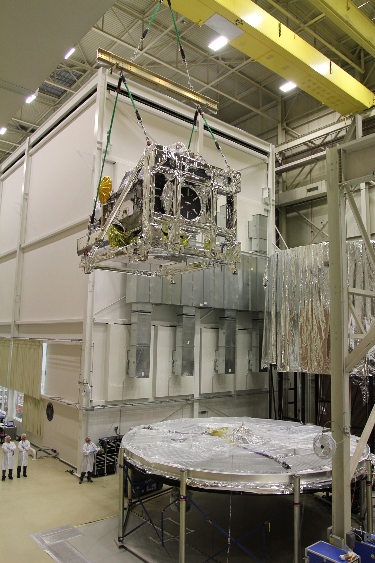 GPM on a cran being lowered into the TVAC chamber