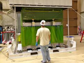 A NASA engineer removing the DPR from its shipping container