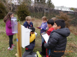 Students working with Rain gauges