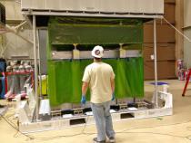 A NASA engineer removing the DPR from its shipping container