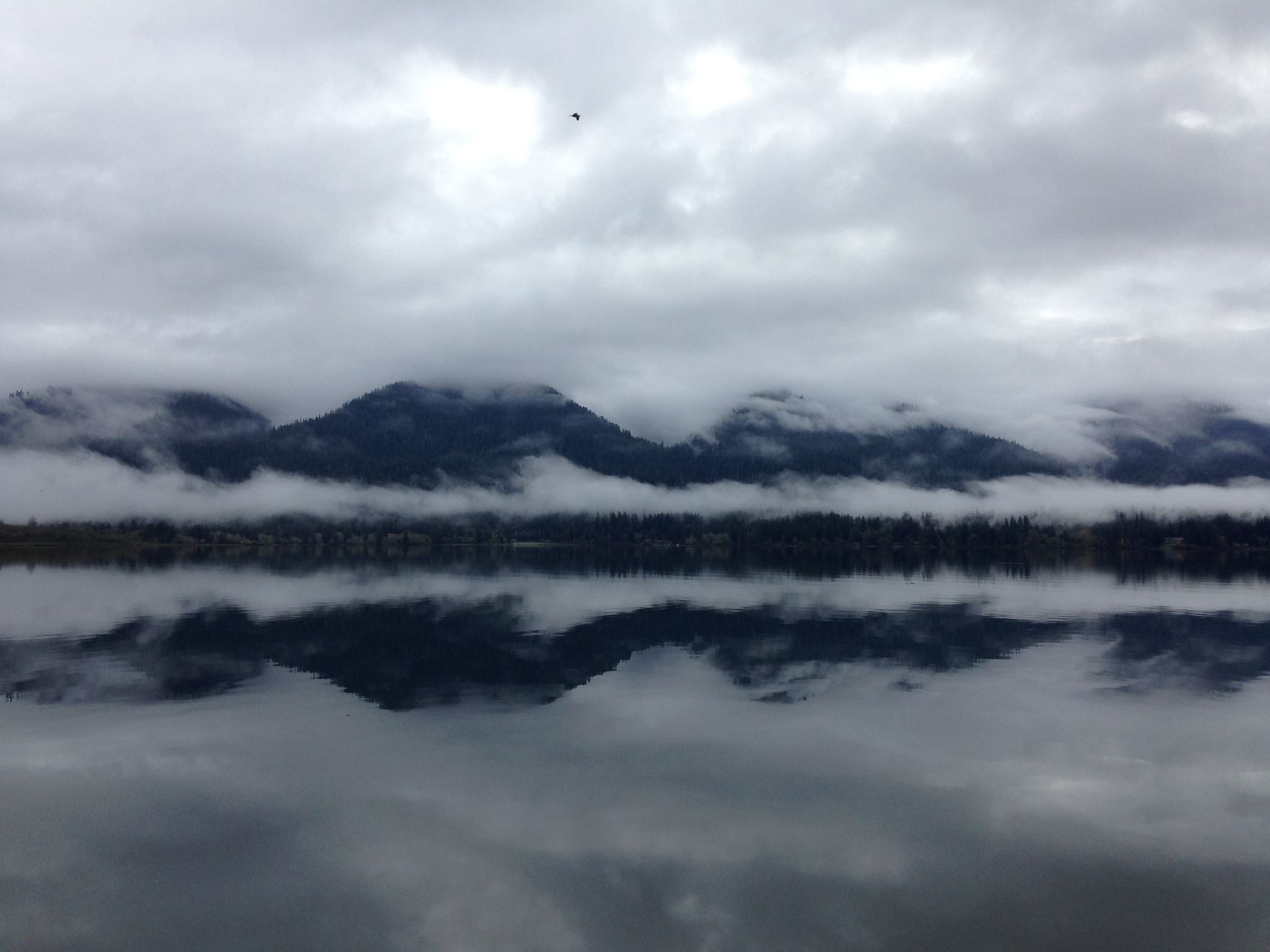 lake reflecting mountains and clouds