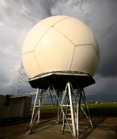 A large spherical radar, with stormy sky